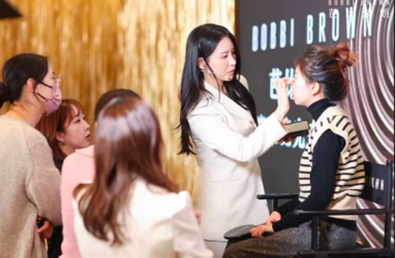 Photo of a silhouette of 2 dancers posing in front of a red curtain.