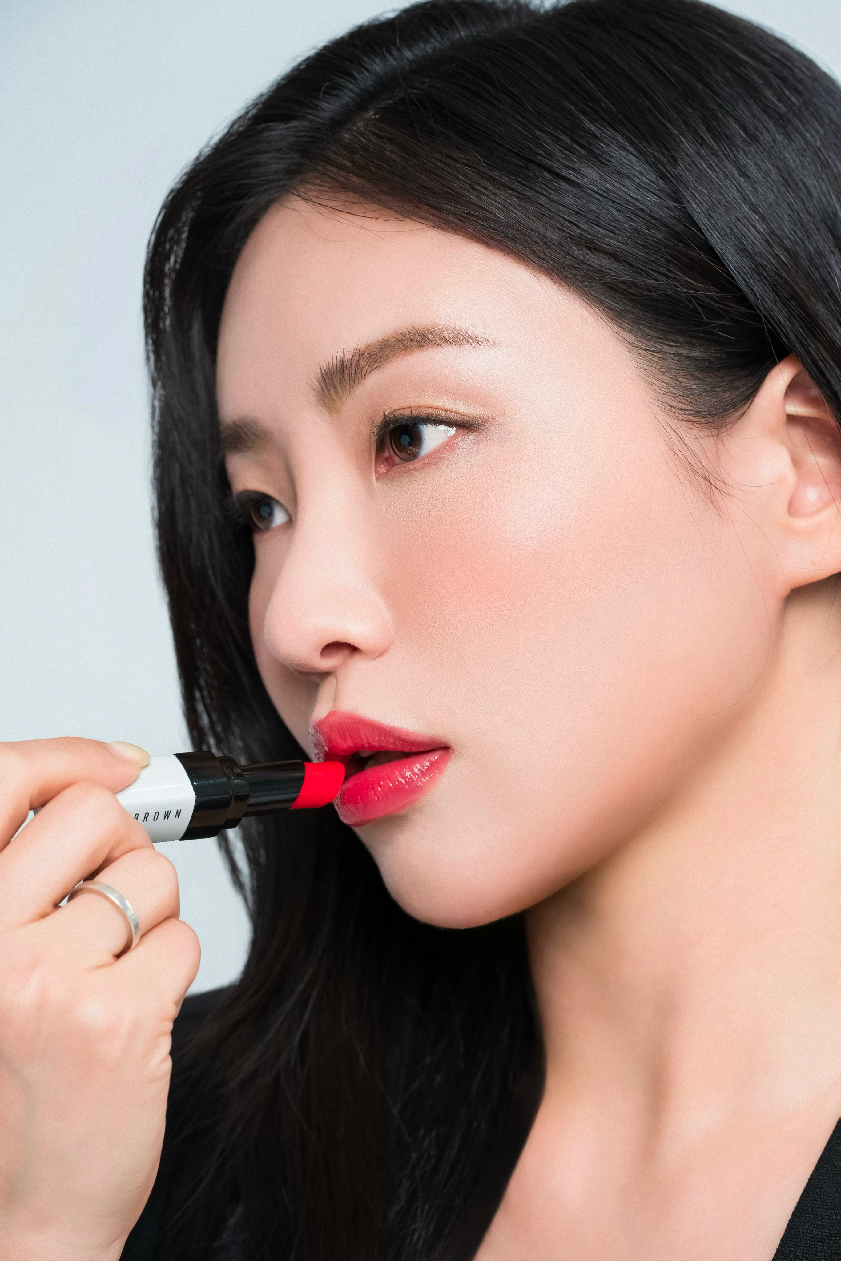 Photo of a silhouette of 2 dancers posing in front of a red curtain.