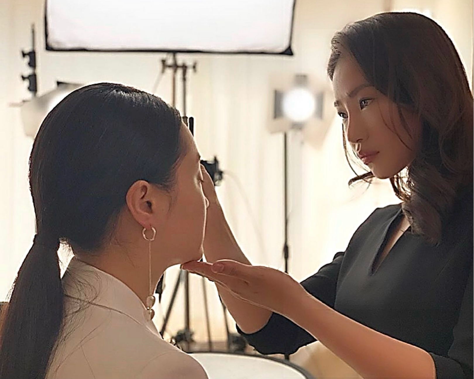 Black and white photo of a women performing modern dance on a dark background.