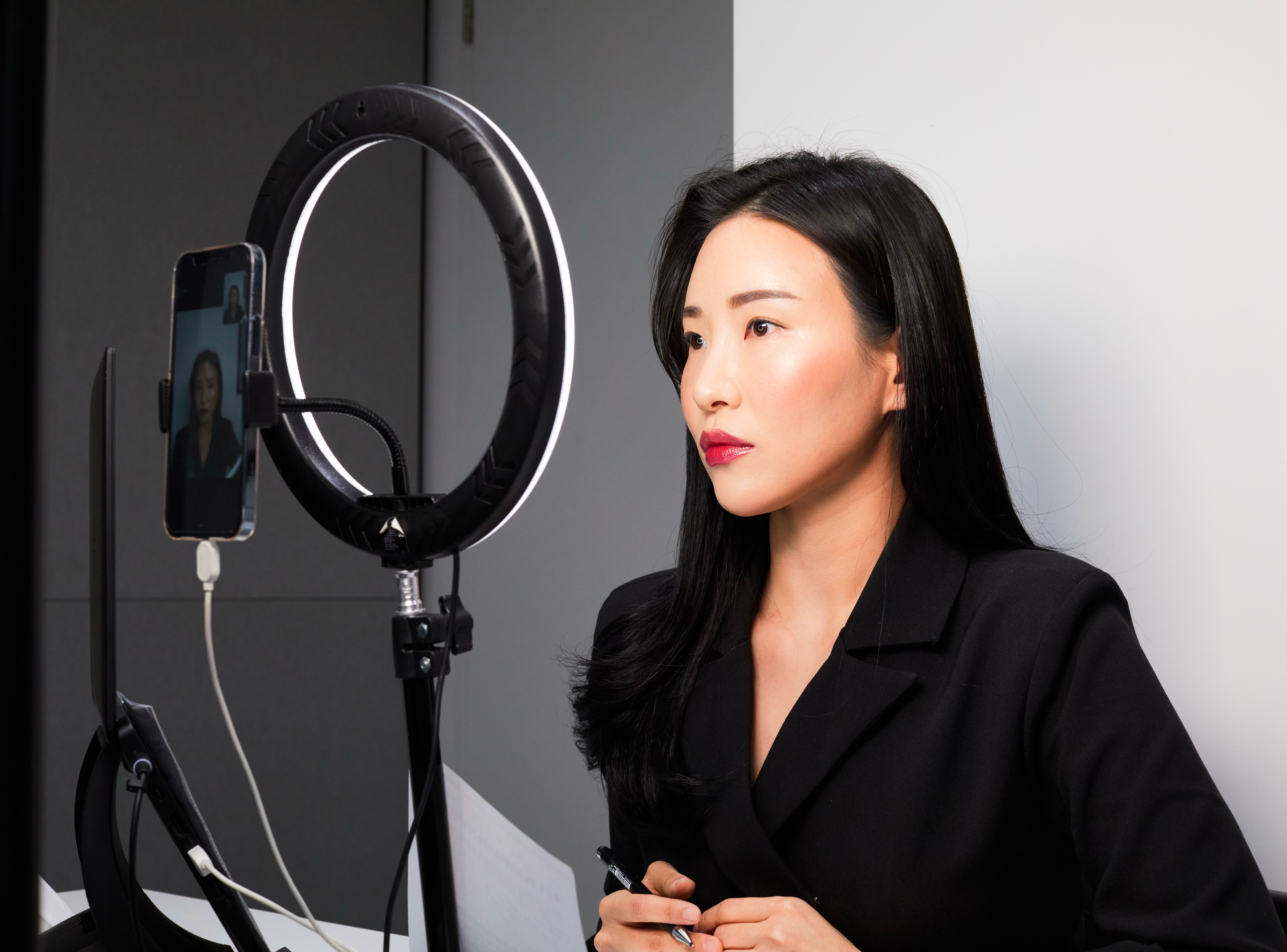 Black and white photo of teens rehearsing a dance routine on a stage.